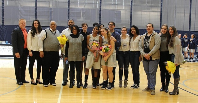 Eva Hart and Noel Hodges, with their family and the Brandeis coaches before the Senior Day game.