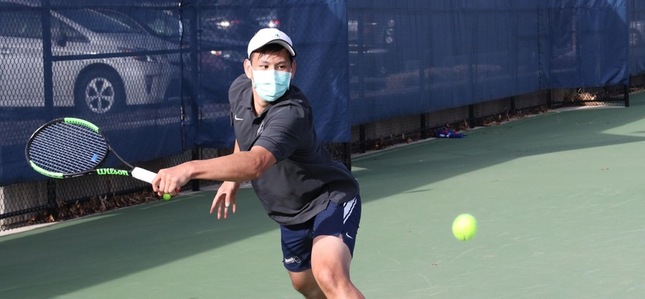 Adam Tzeng chases a ball down on the tennis court