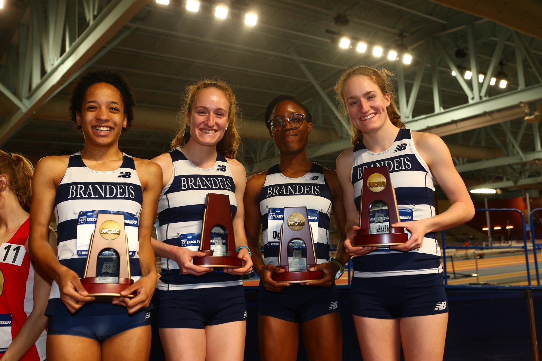 Brandeis distance medley relay team with their All-America awards